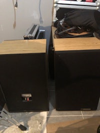 two speakers sitting on top of each other in a room