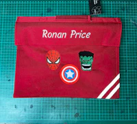 a red school bag with an avengers and hulk logo on it