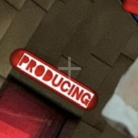 a sign with the word producing on it