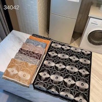 a set of towels in a kitchen with a washing machine