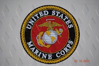 the us marine corps logo is shown on a white wall