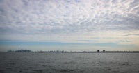 a cloudy sky over a body of water