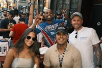 a group of people posing for a picture on a street