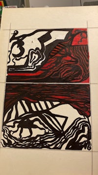 a black and red drawing on a piece of paper