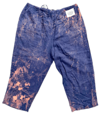 a pair of blue pants with orange paint on them
