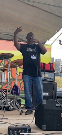 a man standing on stage with a microphone