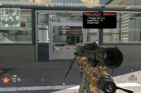 a video game showing a rifle in front of a building