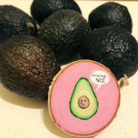 a picture of an avocado with a pink sticker on it
