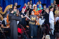 a group of people dressed in costumes and holding instruments