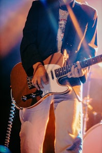 a man playing a guitar on stage