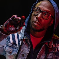 a man in a hoodie holding a phone