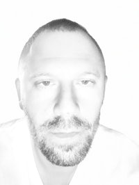 a black and white photo of a man with a beard