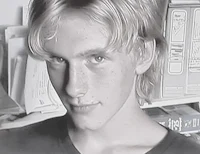 a black and white photo of a young man with blonde hair