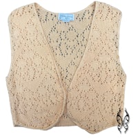 a beige vest with lace on it