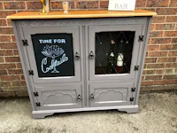 a grey cabinet with a chalkboard sign on it