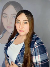 a woman in a plaid shirt is posing for a photo