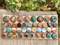 a wooden board with a variety of stones on it