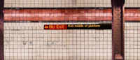 a subway station with a sign on it