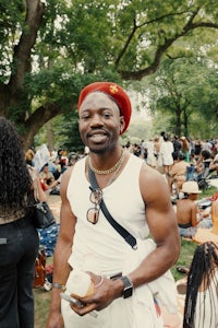 a man in a red hat standing in a crowd of people