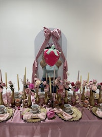 a pink table with a lot of decorations on it