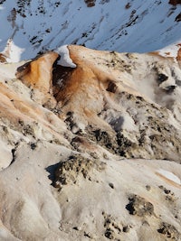 a man is standing on top of a snow covered mountain