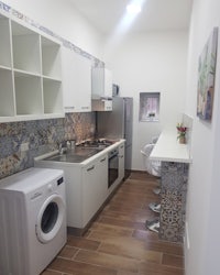 a small kitchen with a washer and dryer