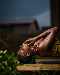 a woman is laying on the ground doing yoga
