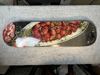 a skateboard with strawberries on it