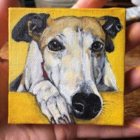 a hand holding a painting of a greyhound on a yellow background
