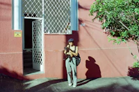 a woman standing in front of a red building