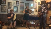a group of people playing music in a bar