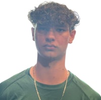 a young man in a green shirt with a necklace