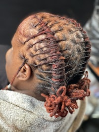 the back of a woman's hair with dreadlocks