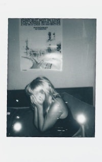 a black and white photo of a woman laying on a bed