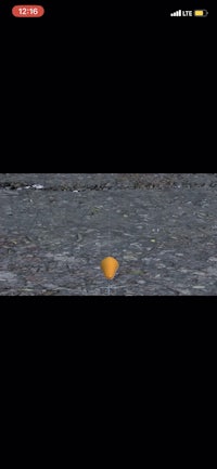 a screen shot of an orange ball in the water