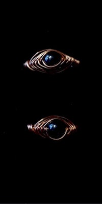 a pair of copper rings with blue stones on them