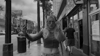 a black and white photo of a woman taking a selfie