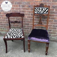 two chairs with zebra print cushions in front of a brick wall