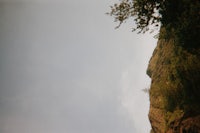 a person is flying a kite over a hill
