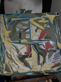 an abstract painting on a table in a studio