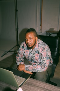 a man sitting in a chair with a laptop