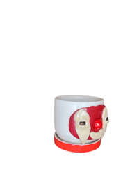a clown mug with a red face on it