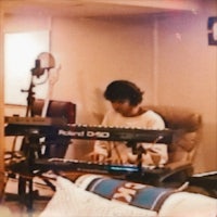 a person playing a keyboard in a room