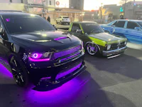 a black and purple dodge ram parked in a parking lot