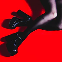 a woman's legs in black stockings on a red background