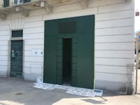 a green door on the side of a building