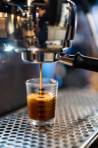 an espresso machine is being used to make a cup of coffee