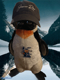 a stuffed penguin wearing a hat
