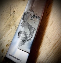 a knife with an image of a dragon on it