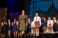 a group of girls in uniform standing on stage